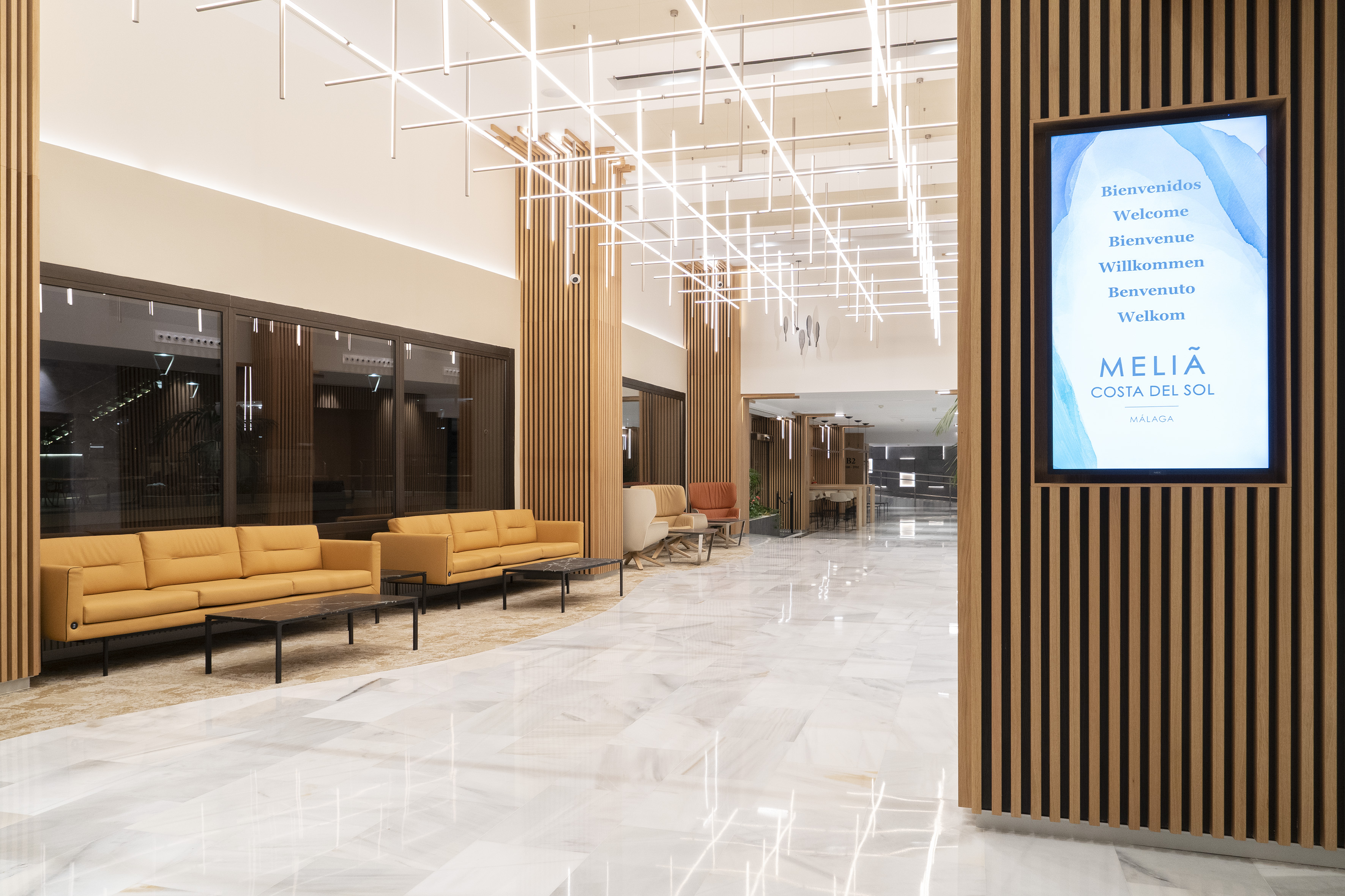 a large room with a television screen and chairs