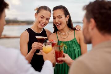 a group of people holding drinks