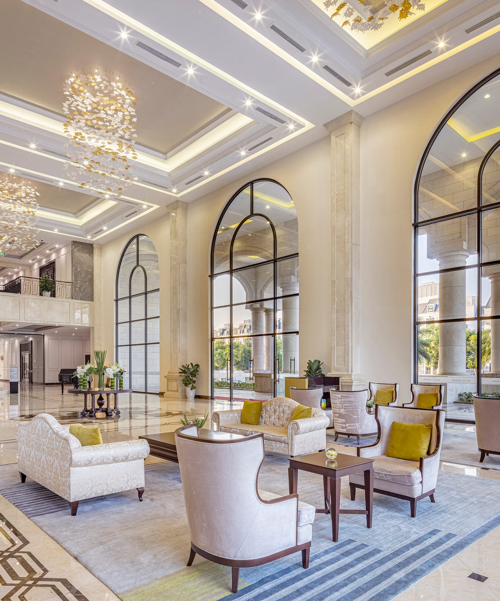 a large lobby with a large staircase and chairs