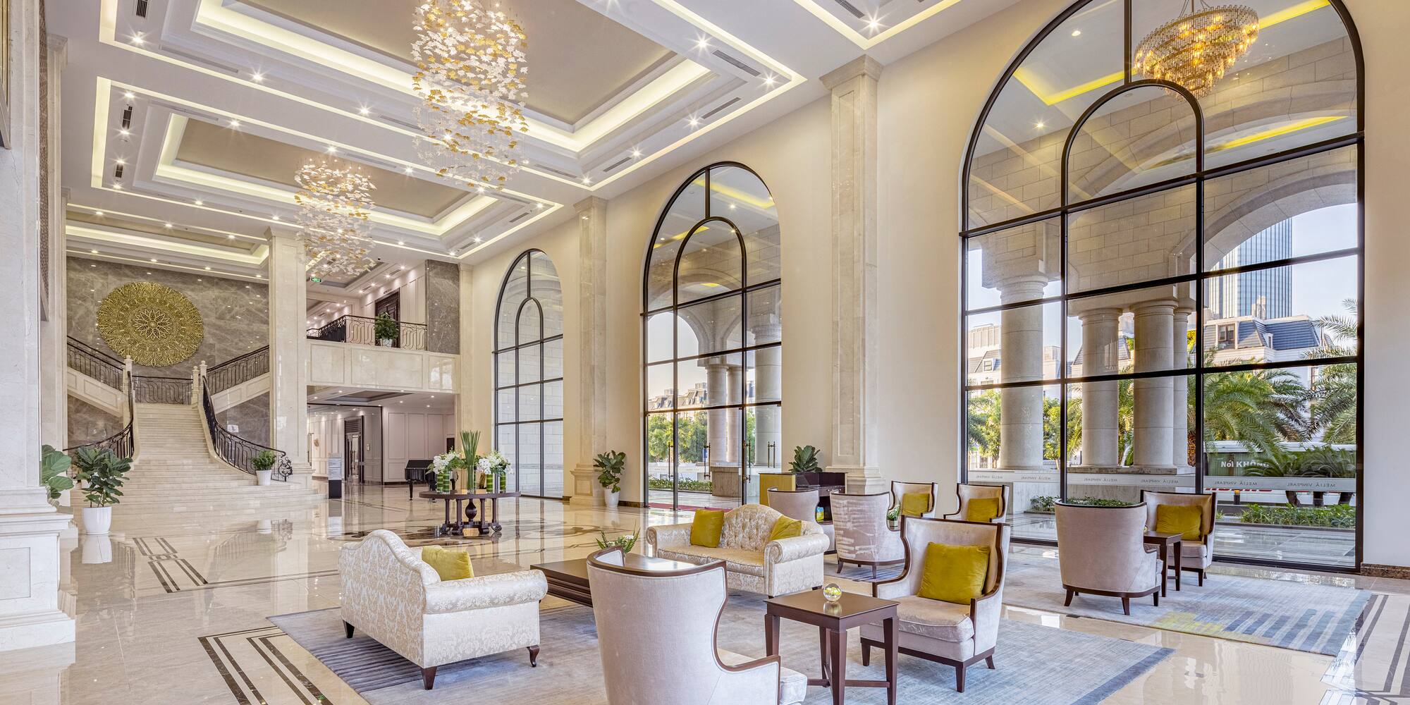 a large lobby with a large staircase and chairs