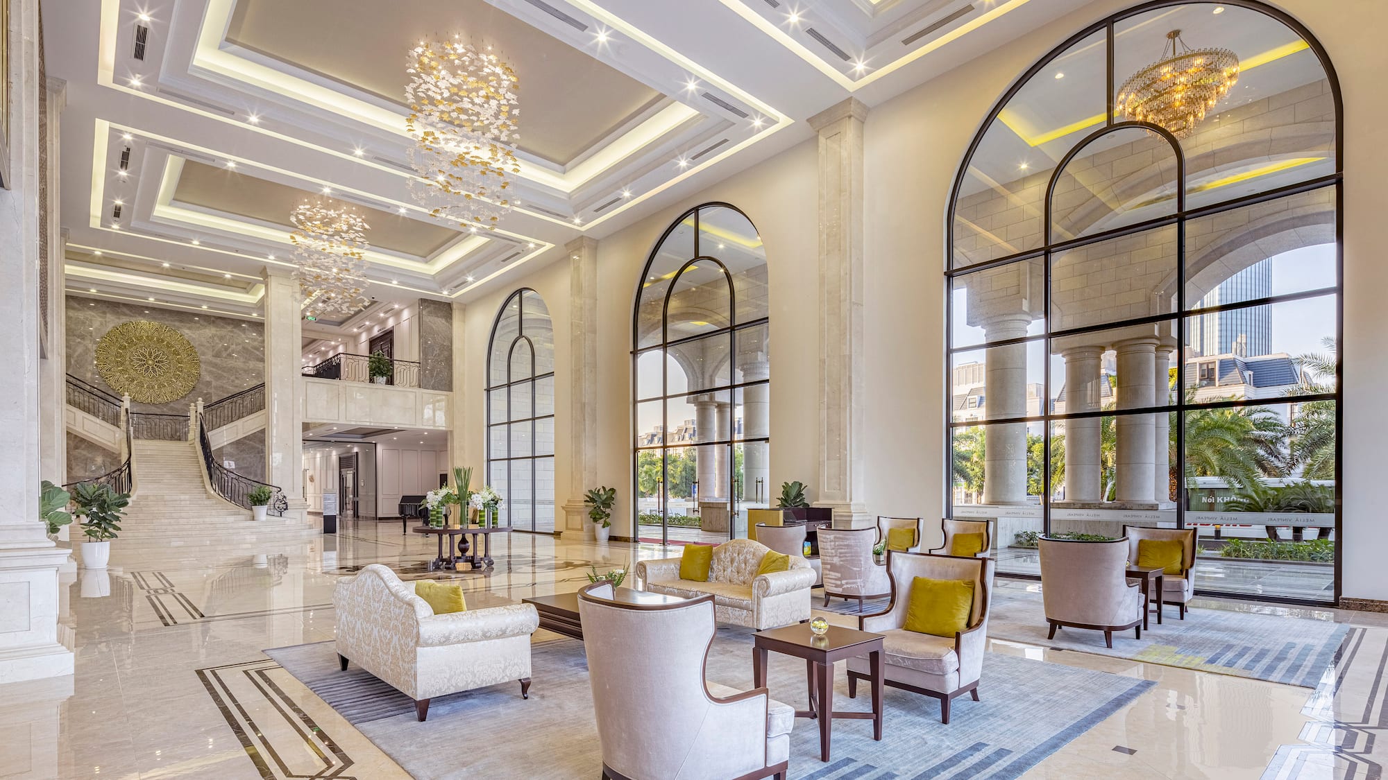 a large lobby with a large staircase and chairs