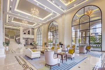 a large lobby with a large staircase and chairs