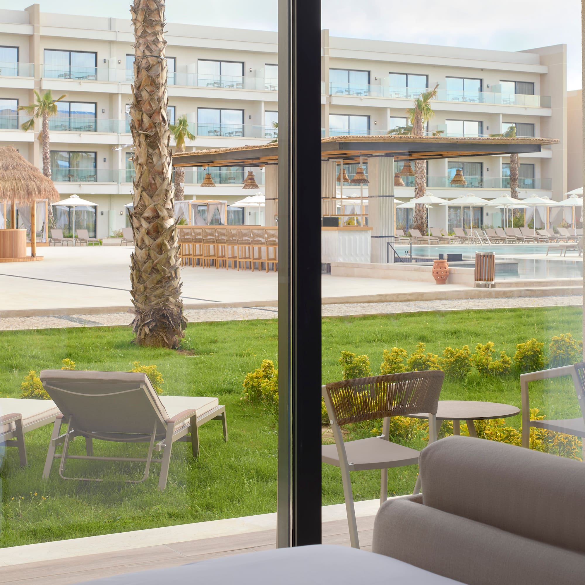 a room with a pool and chairs
