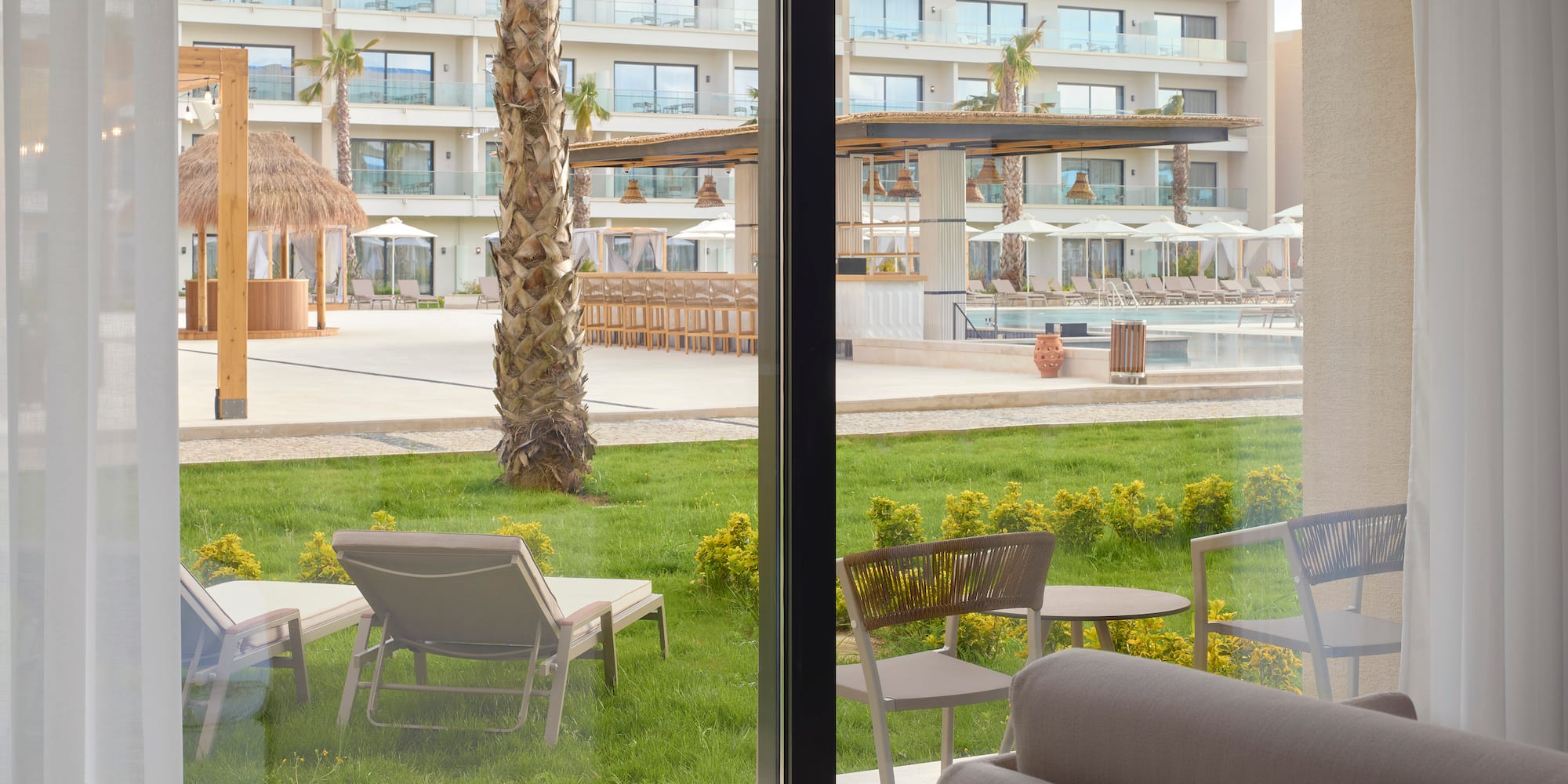 a room with a pool and chairs