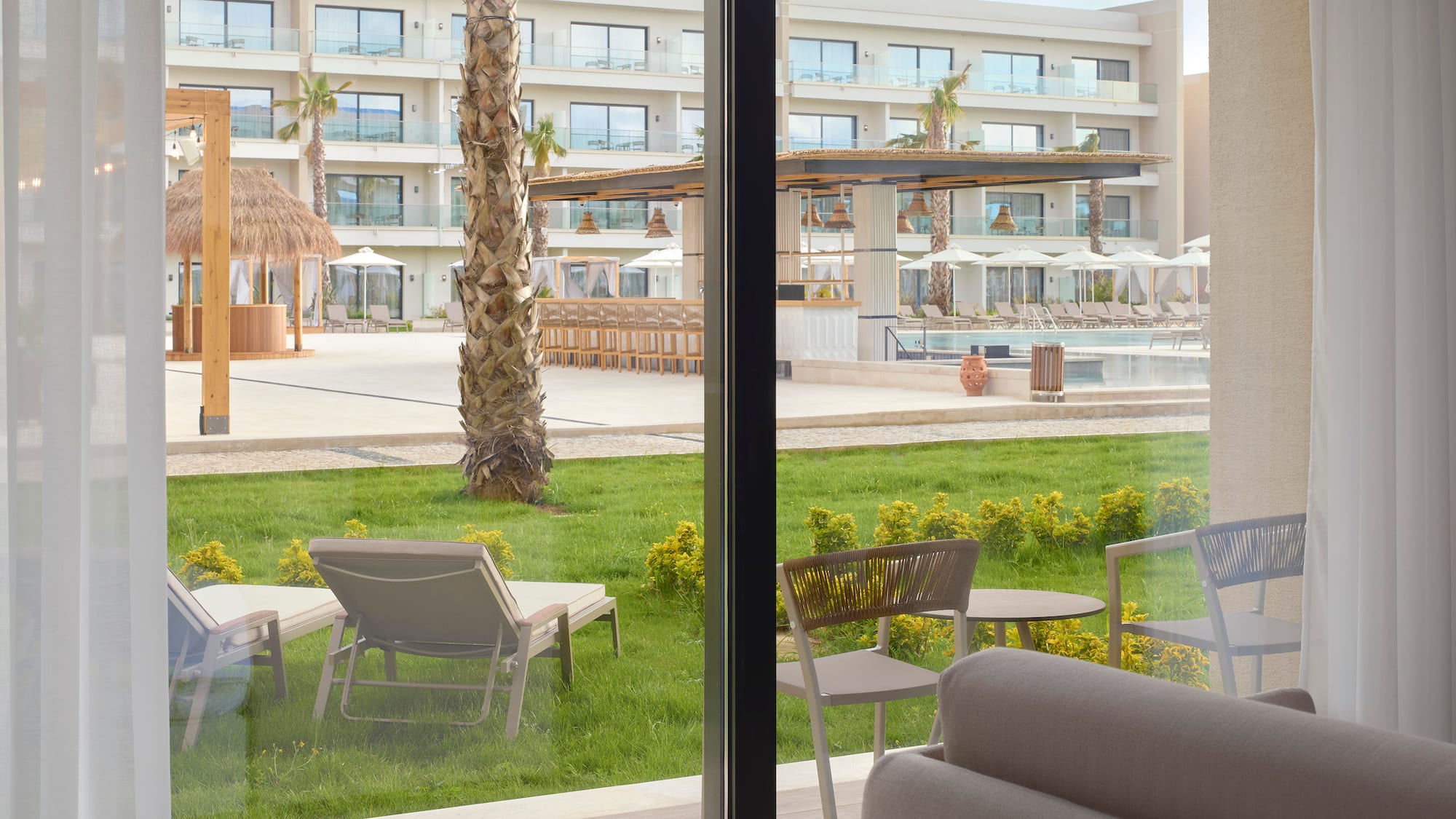 a room with a pool and chairs