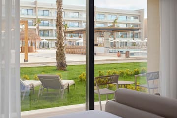 a room with a pool and chairs