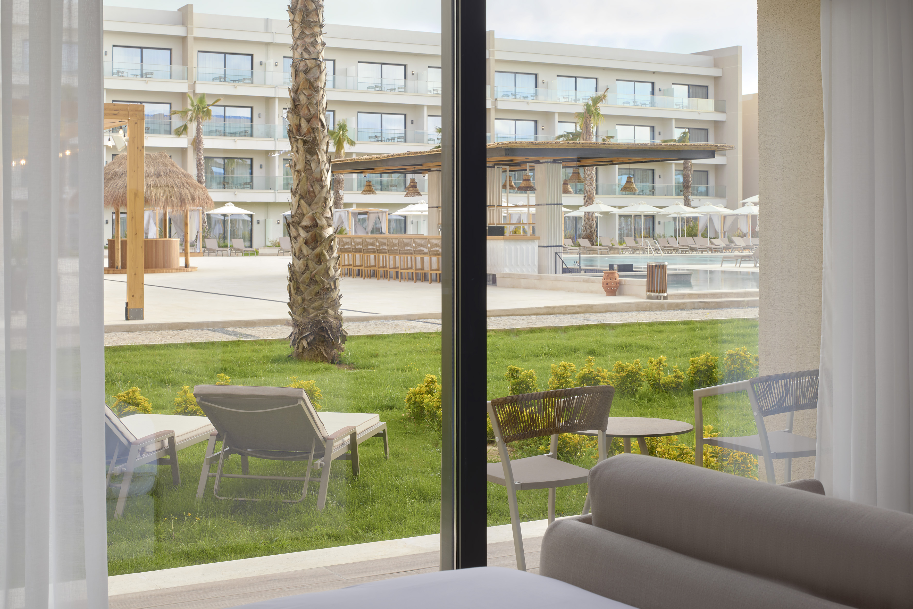 a room with a pool and chairs