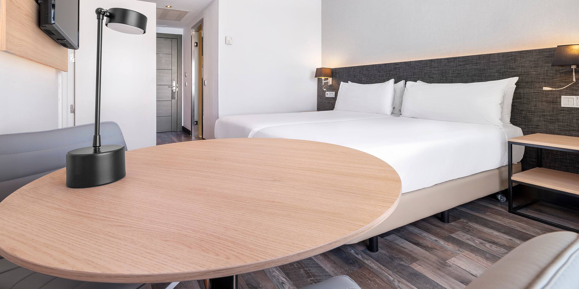 a room with a round table and a lamp