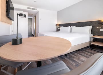 a room with a round table and a lamp