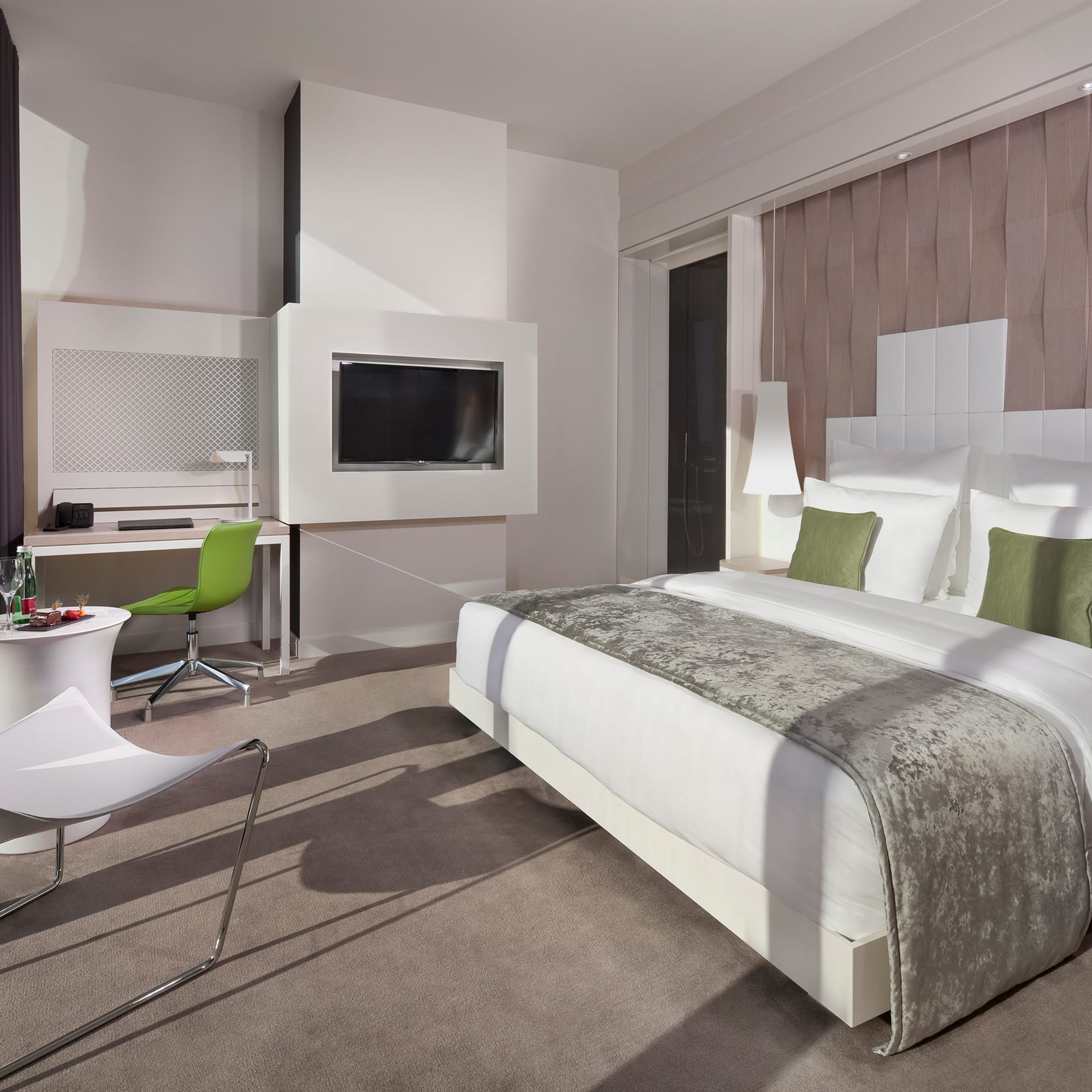 a room with a bed and a television