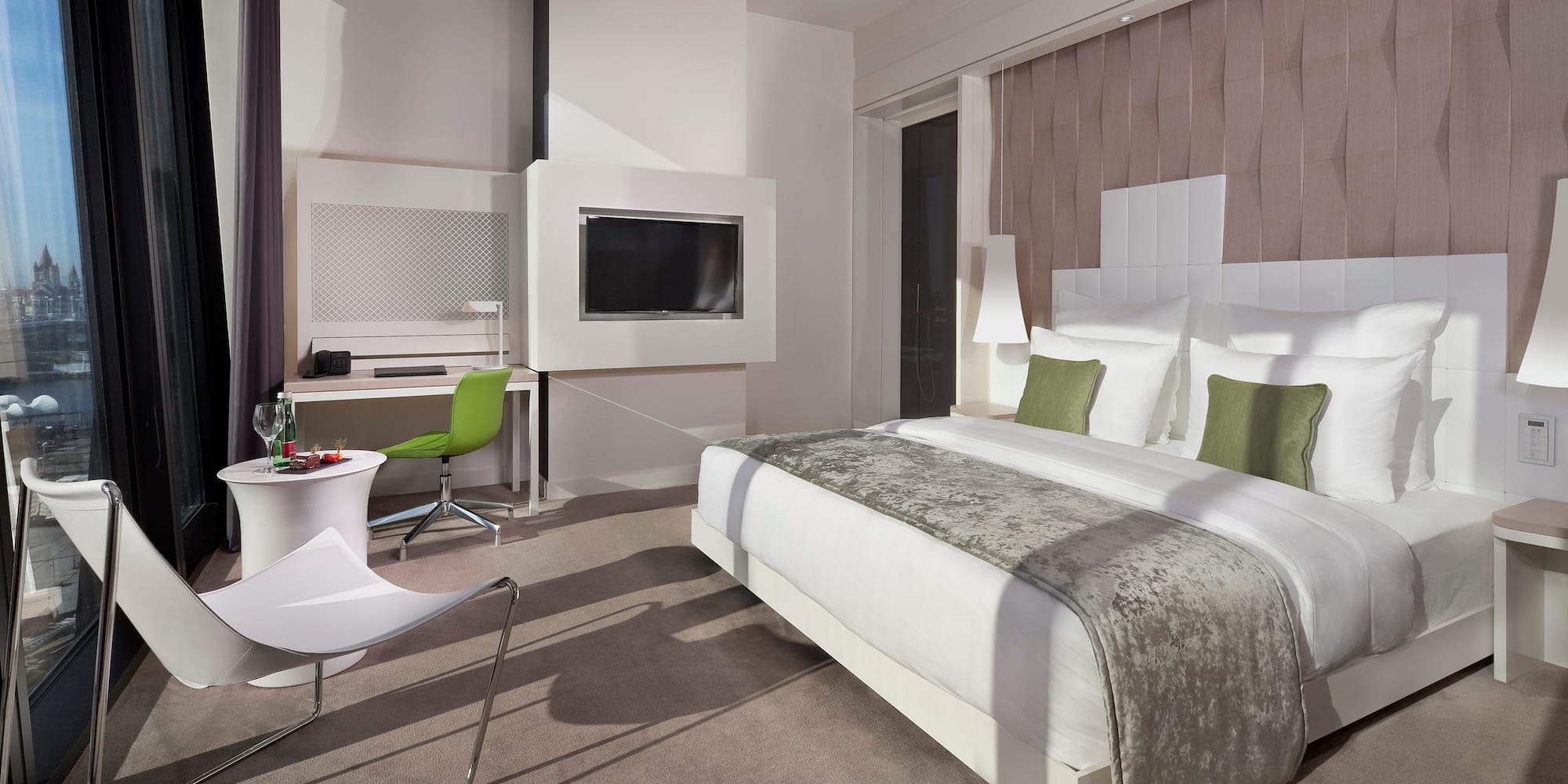 a room with a bed and a television