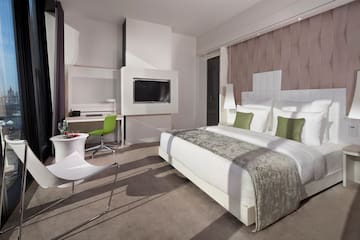 a room with a bed and a television