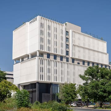 a white building with trees and blue sky