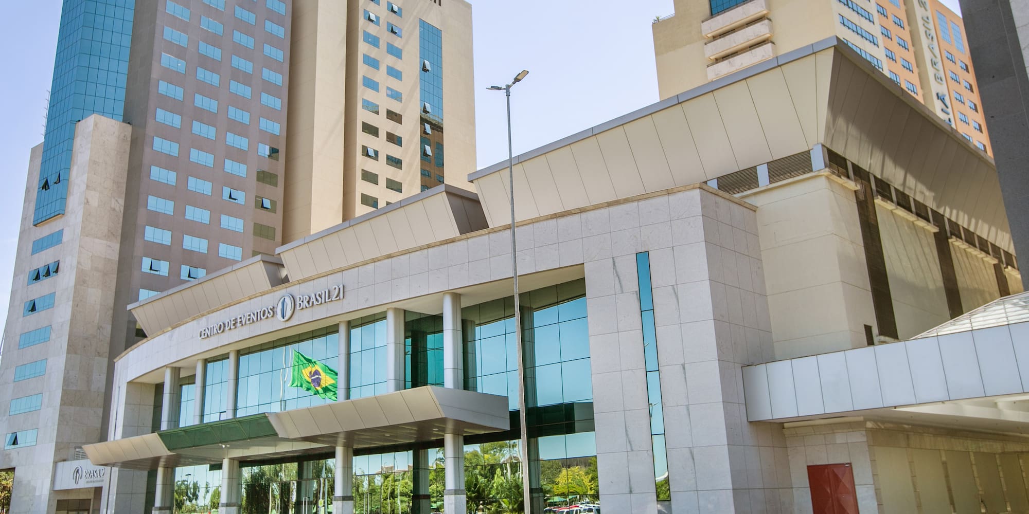 a building with glass windows and a flag on the front