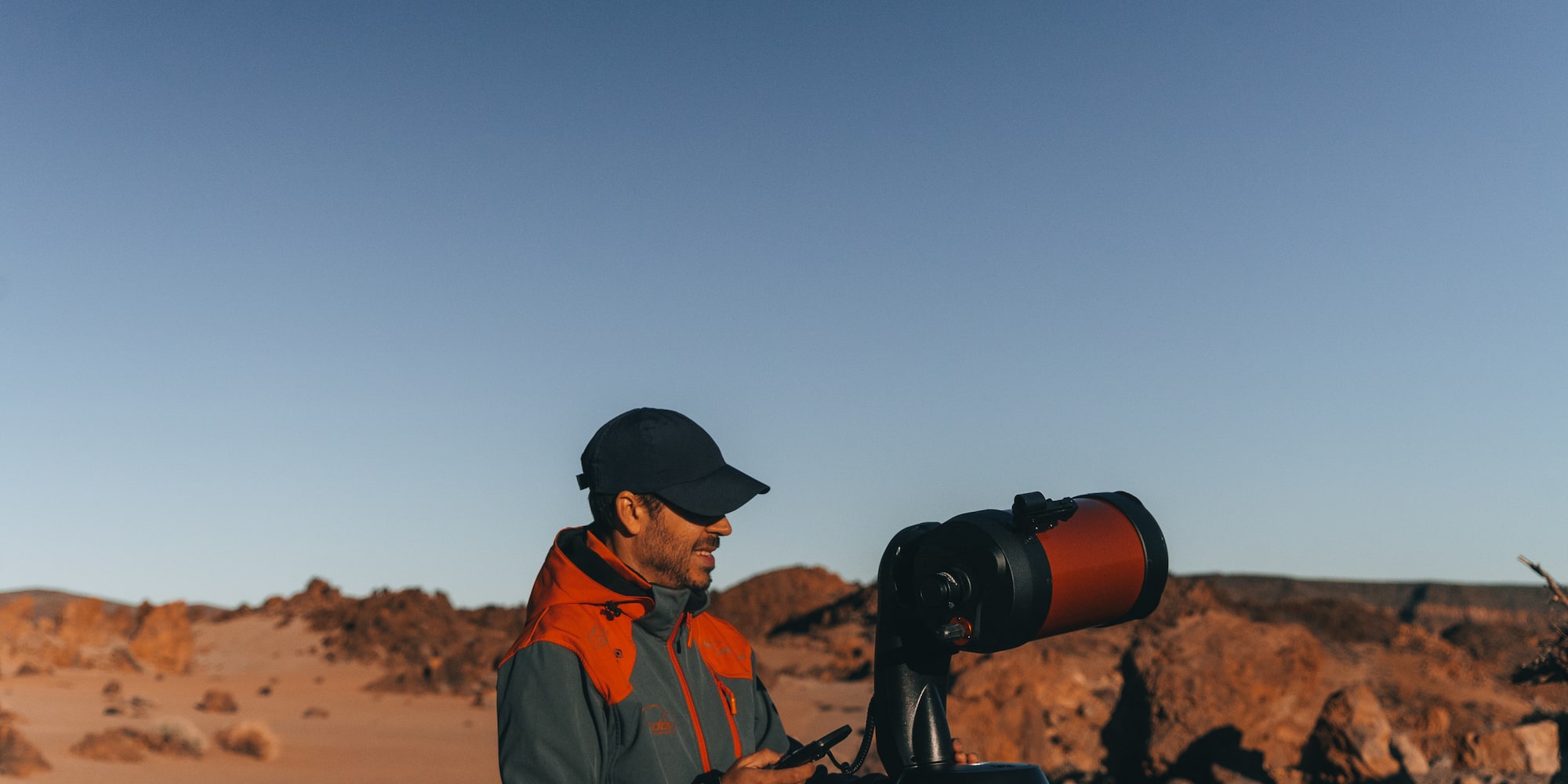 a man looking at a telescope