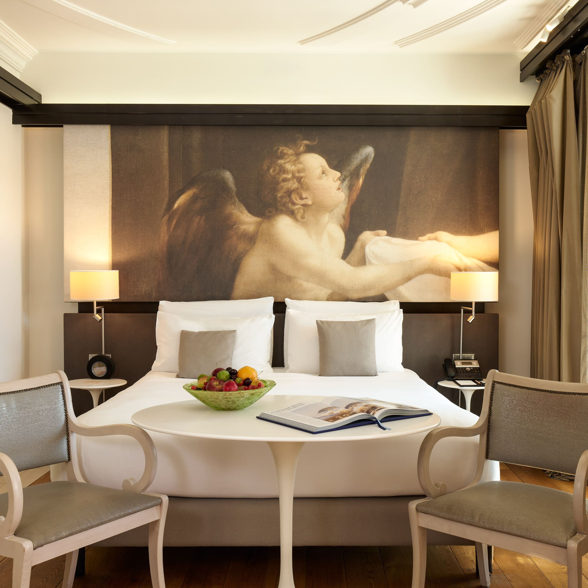 a room with a bed and chairs