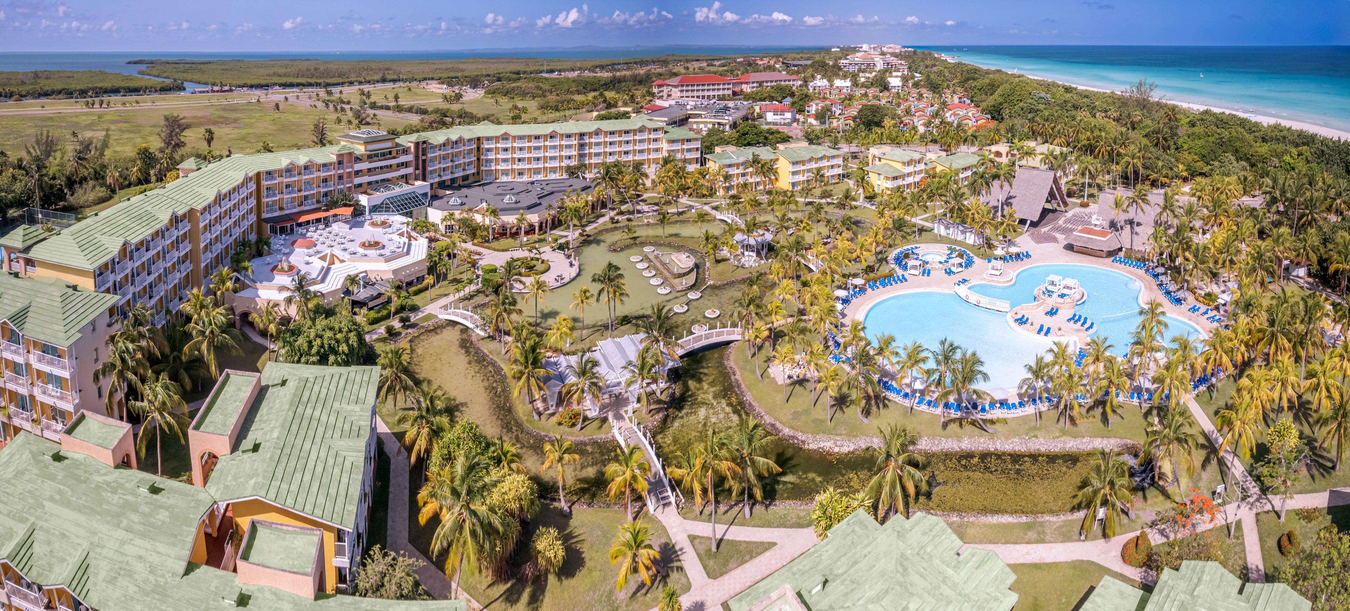 a resort with a pool and palm trees