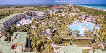 a resort with a pool and palm trees