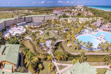 a resort with a pool and palm trees
