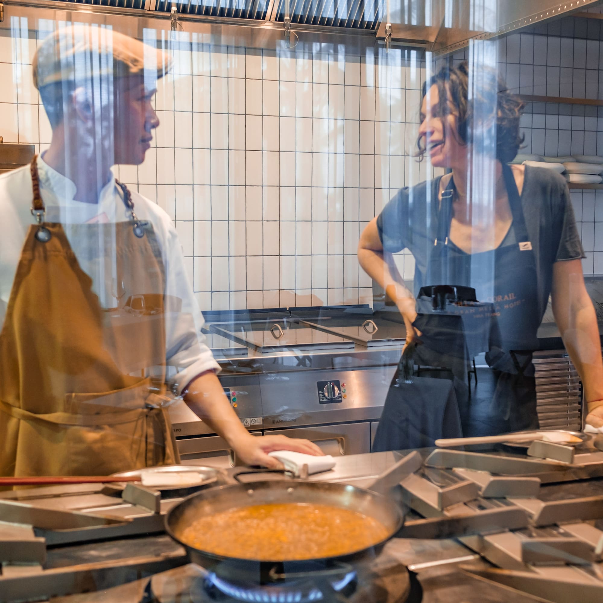 a man and woman in a kitchen