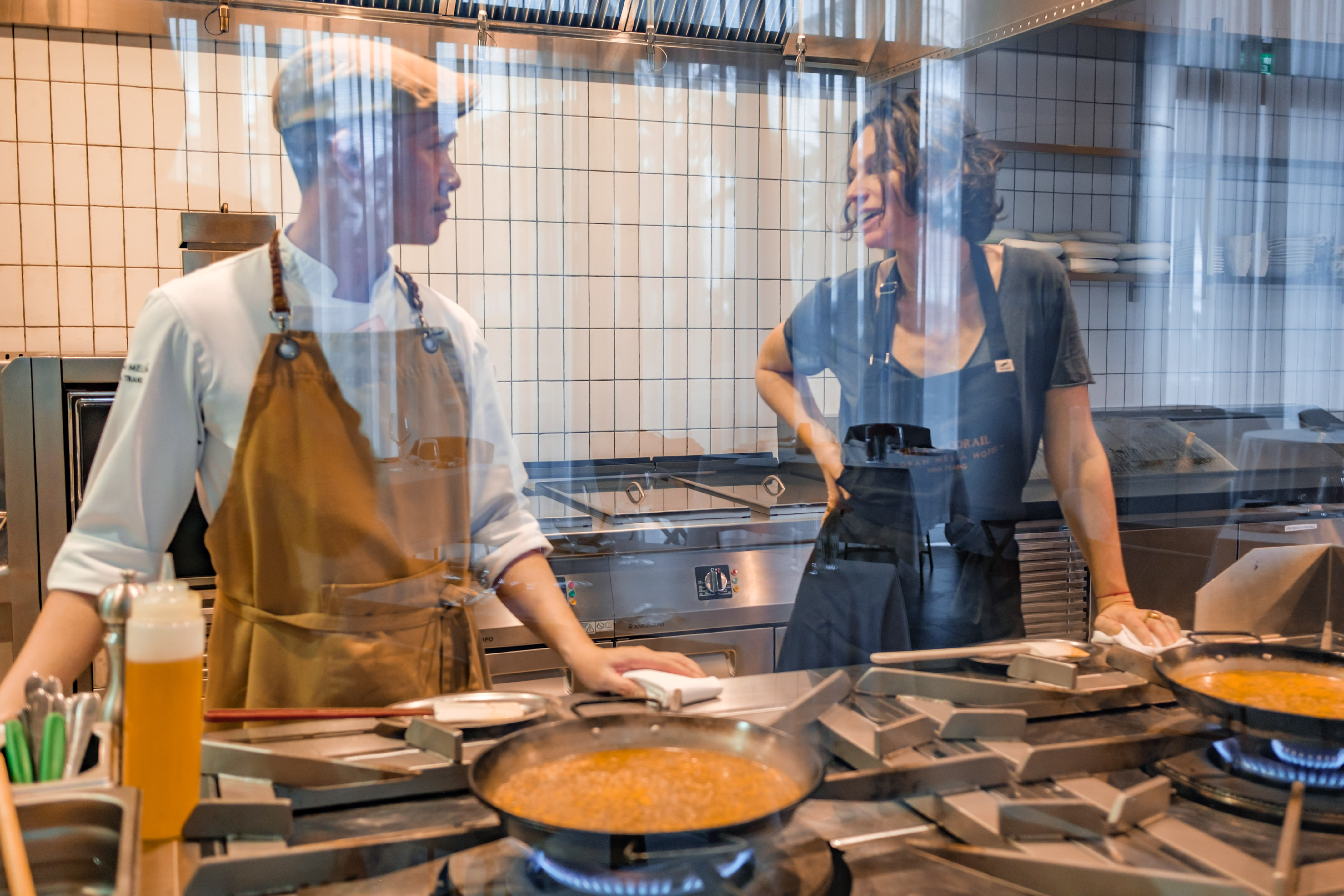 a man and woman in a kitchen