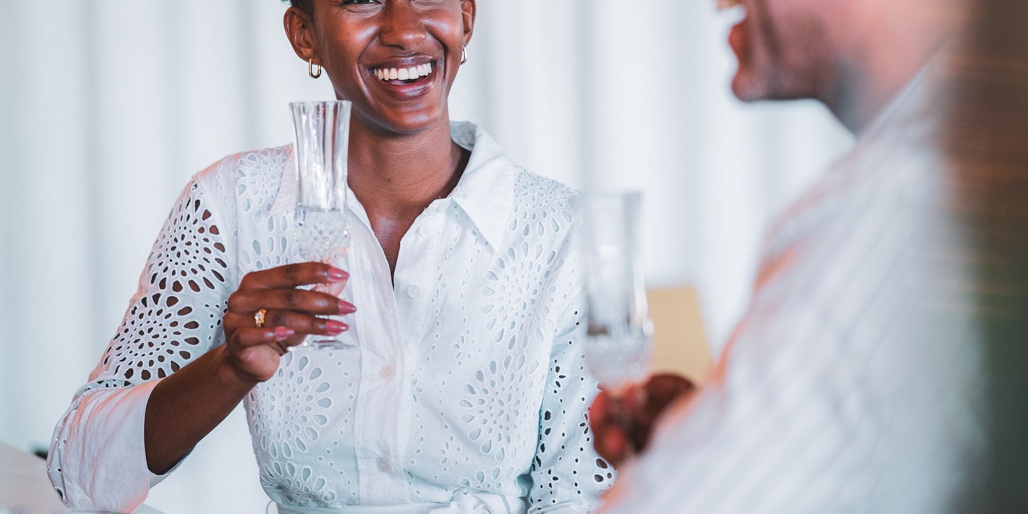 a man and woman holding glasses
