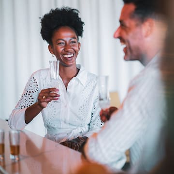 a man and woman holding glasses