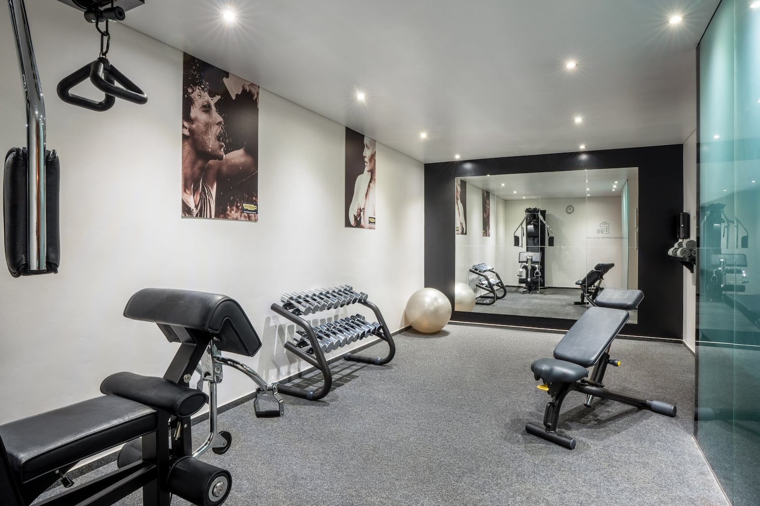 a room with exercise equipment and a mirror