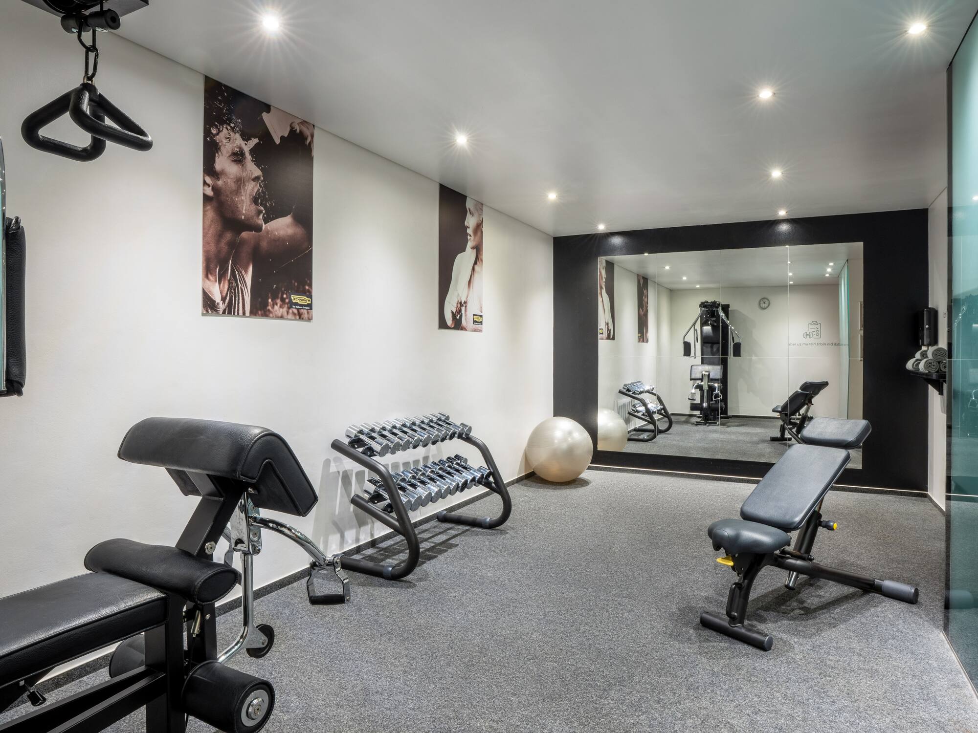 a room with exercise equipment and a mirror