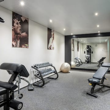 a room with exercise equipment and a mirror