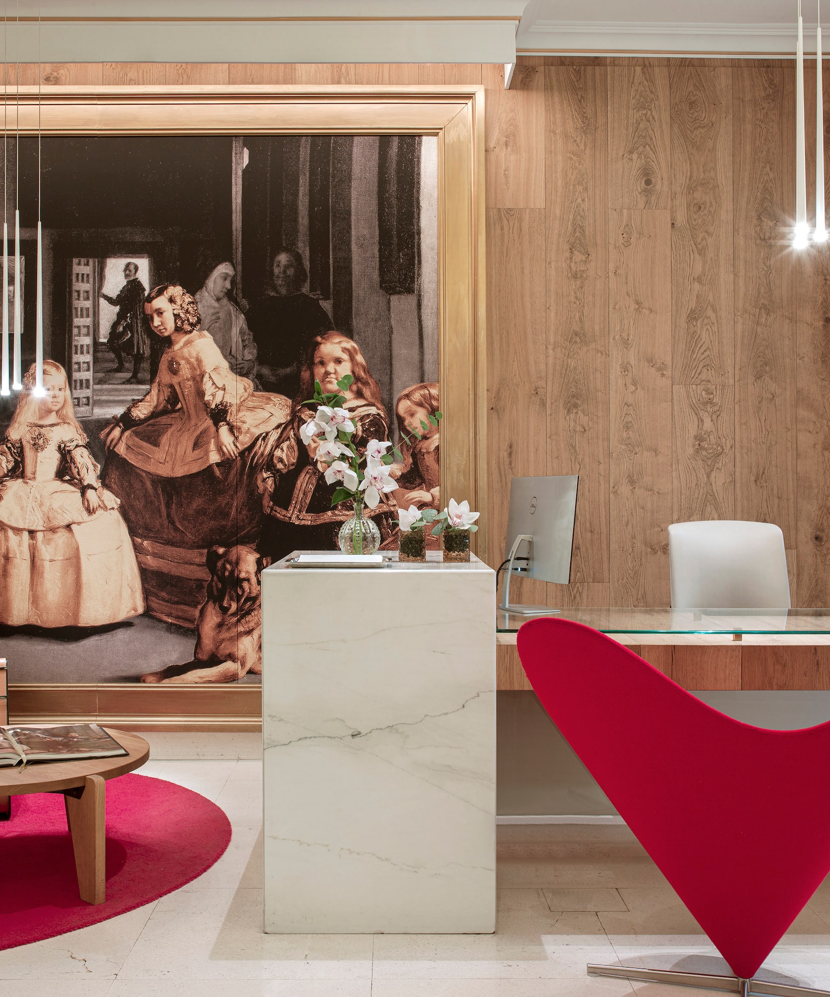 a desk in a room with a large painting on the wall