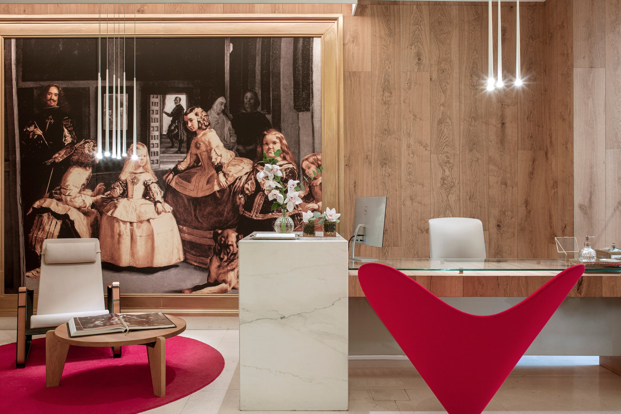 a desk in a room with a large painting on the wall