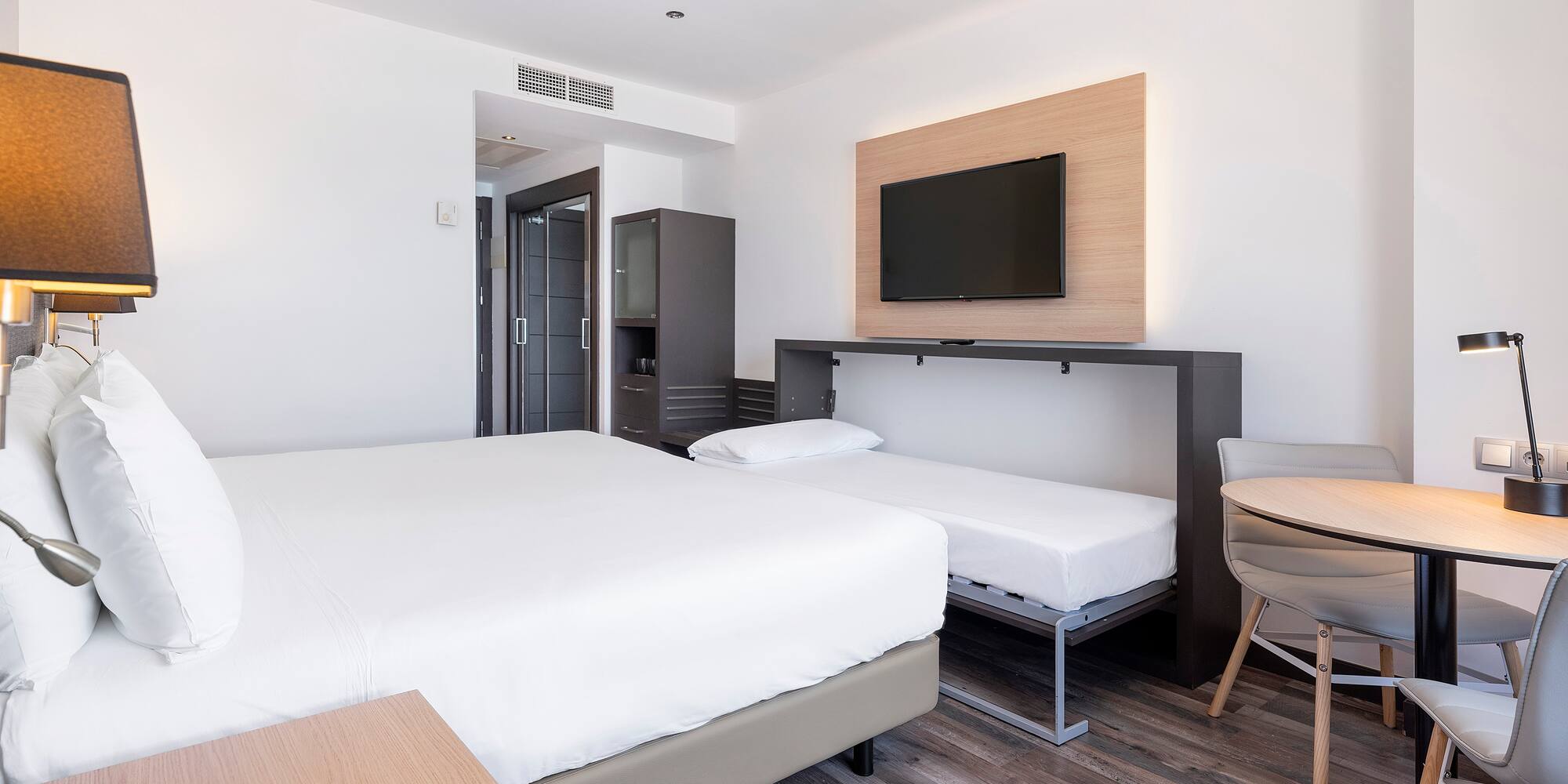 a room with a bed and a tv