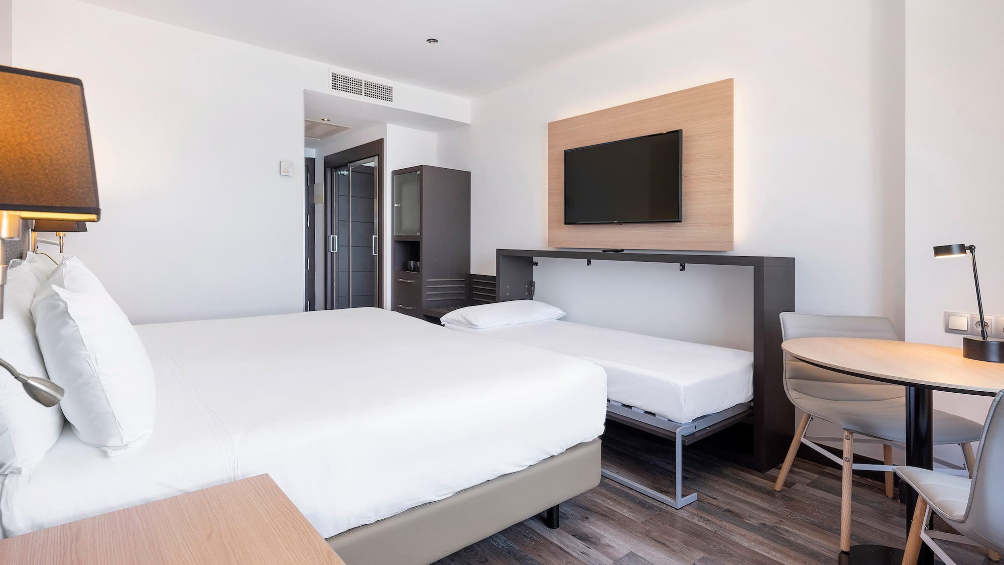 a room with a bed and a tv