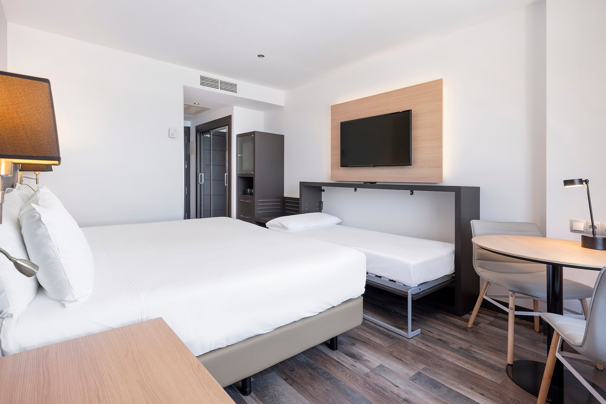 a room with a bed and a tv