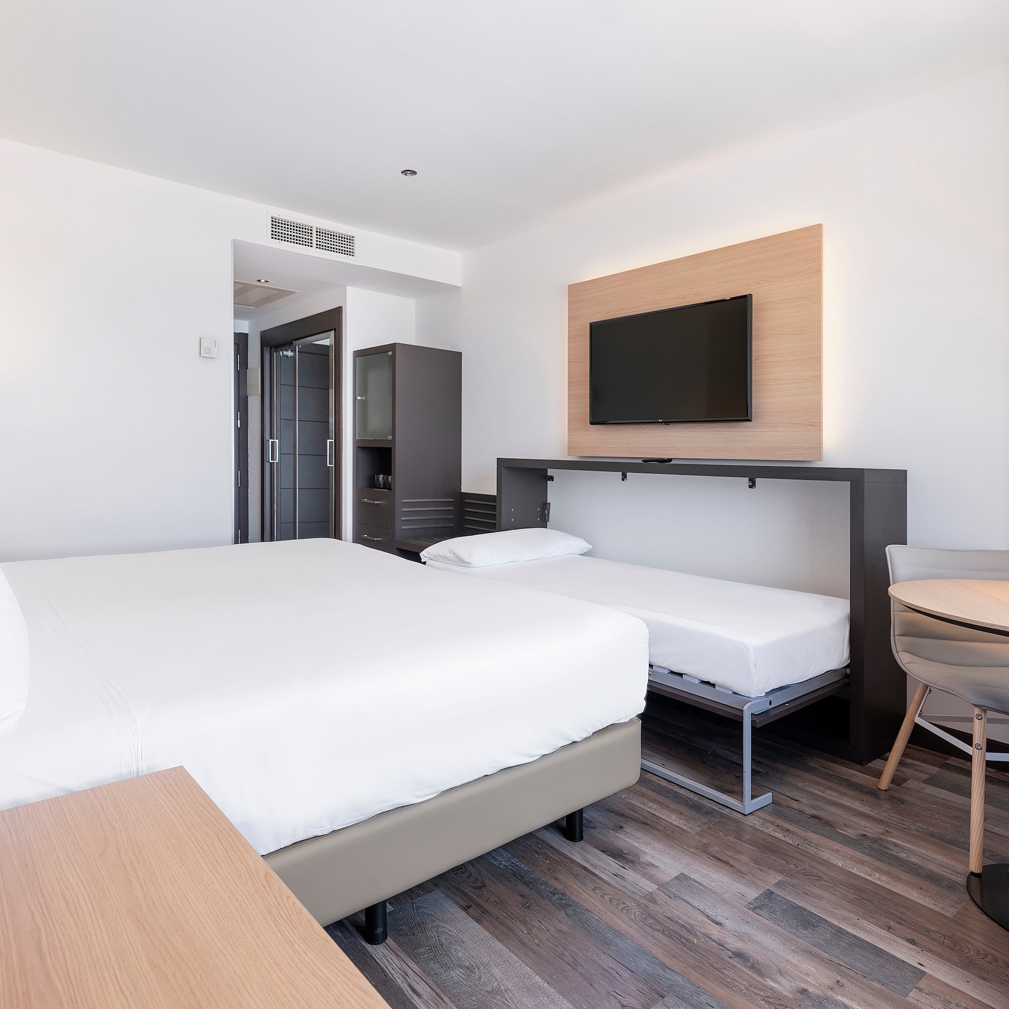 a room with a bed and a tv