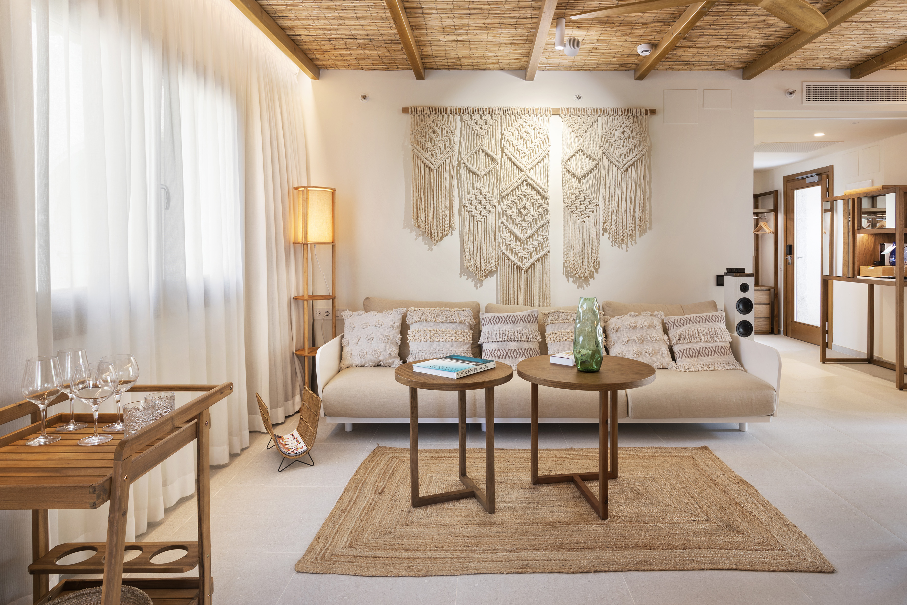 Bohemian living room with macrame wall decor, natural wood and jute textures.