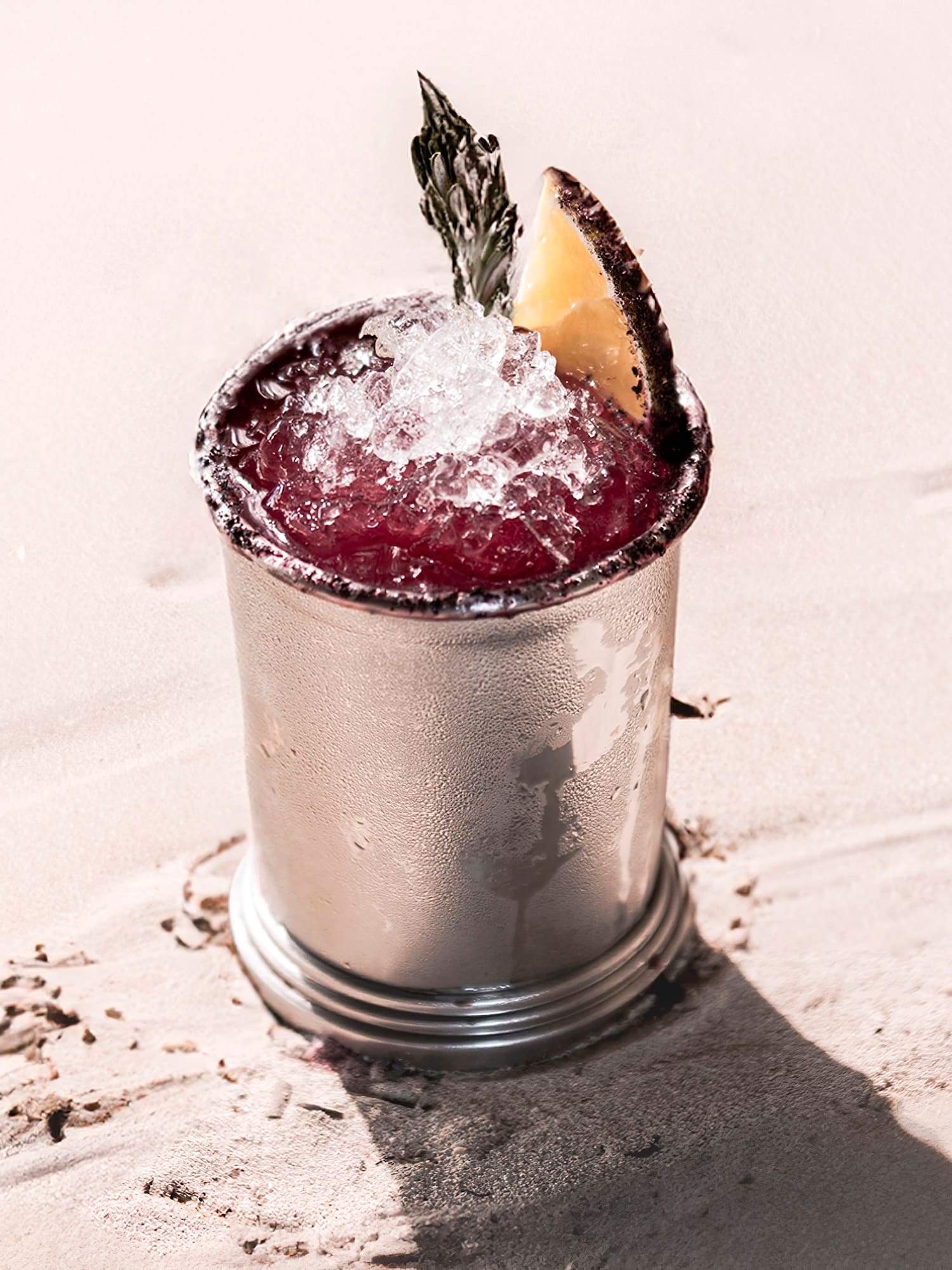 a silver cup with a drink in it