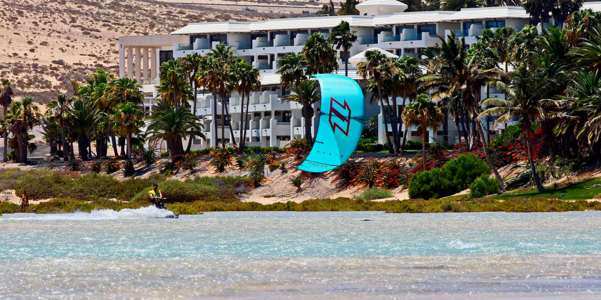 a person parasailing on a beach