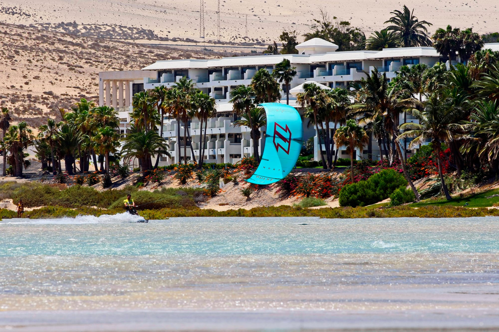 a person parasailing on a beach