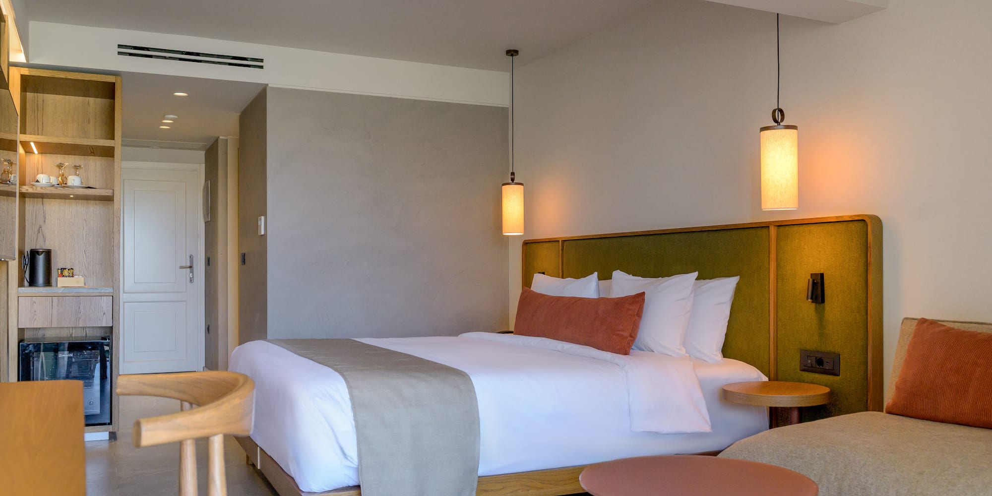 a bed with a table and chairs in a room.