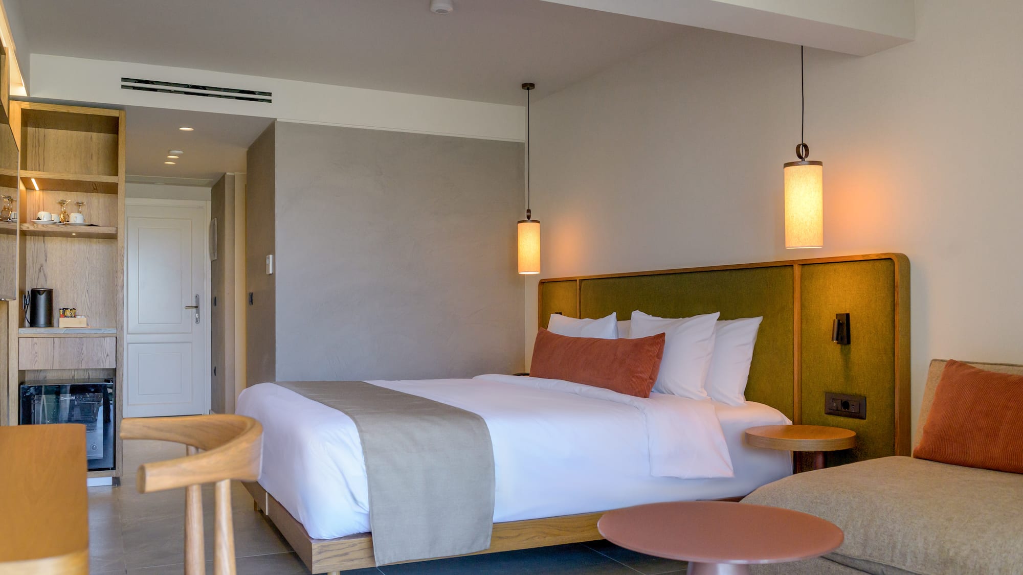 a bed with a table and chairs in a room.