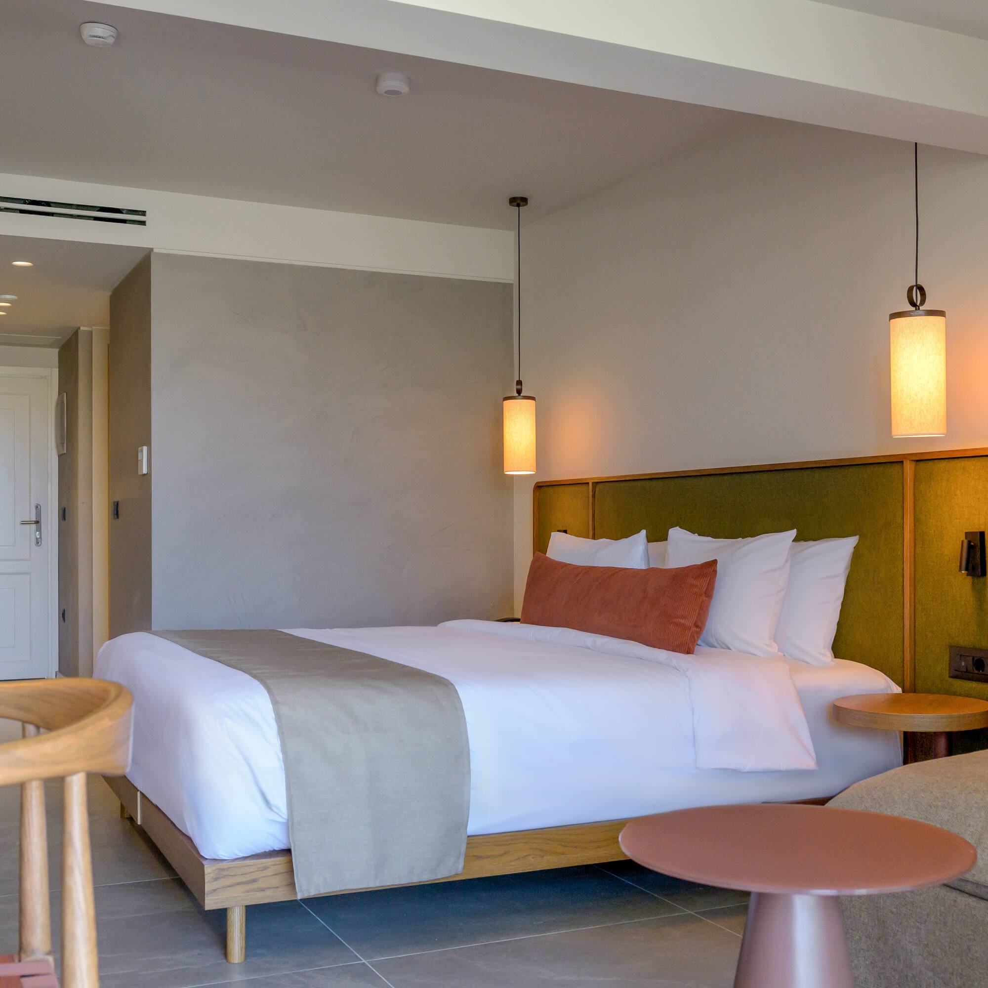 a bed with a table and chairs in a room.