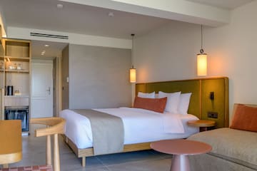 a bed with a table and chairs in a room.