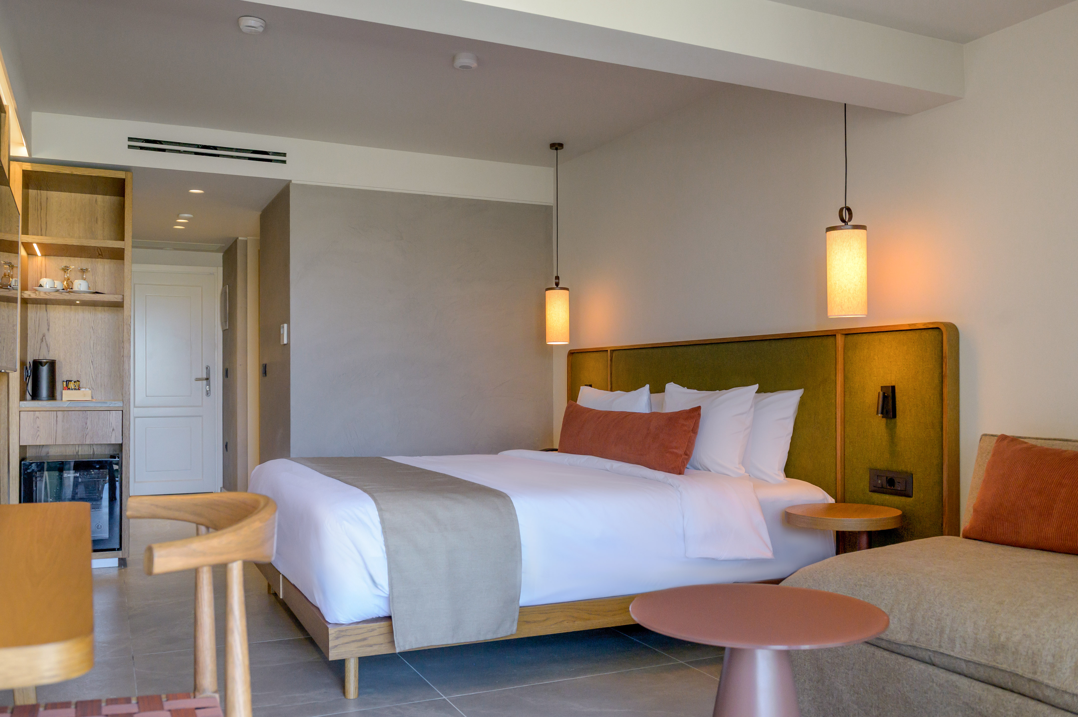 a bed with a table and chairs in a room.