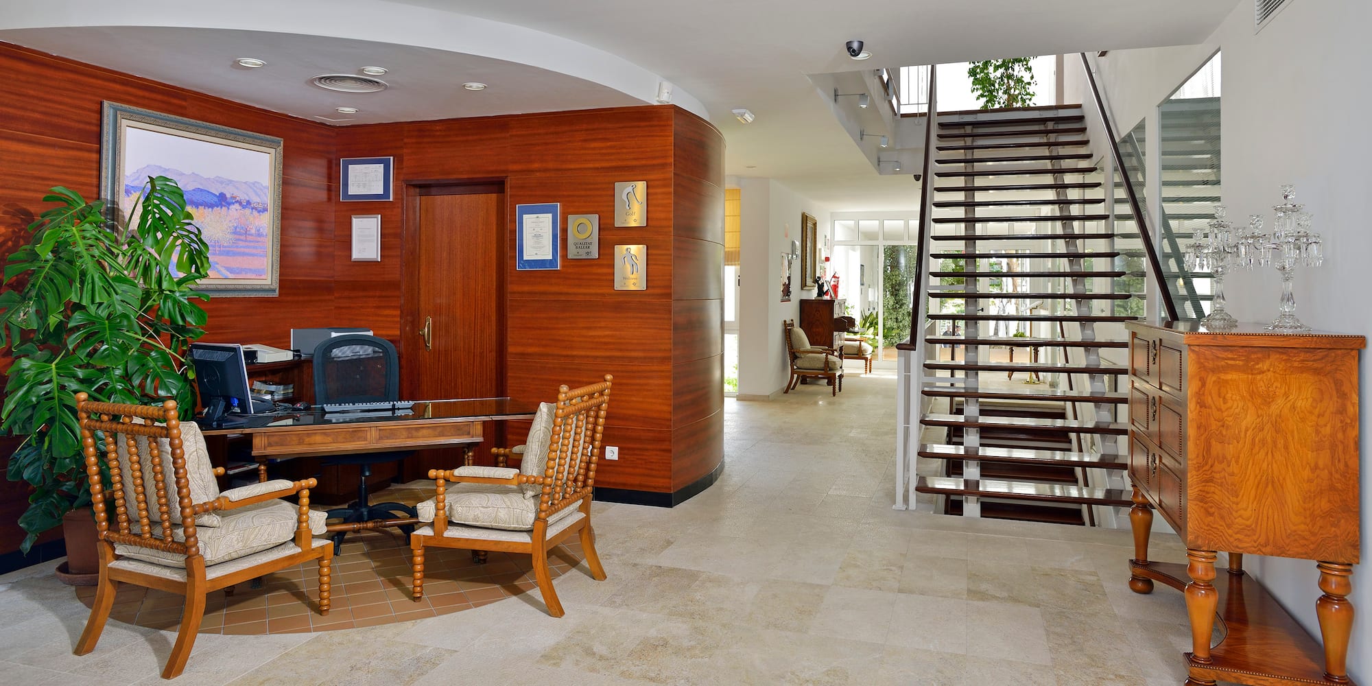 a room with a staircase and a desk