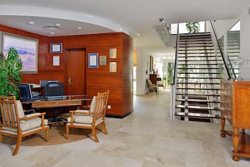 a room with a staircase and a desk