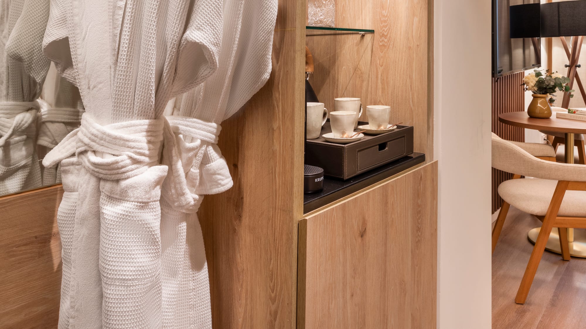 a white robe on a rack in a room