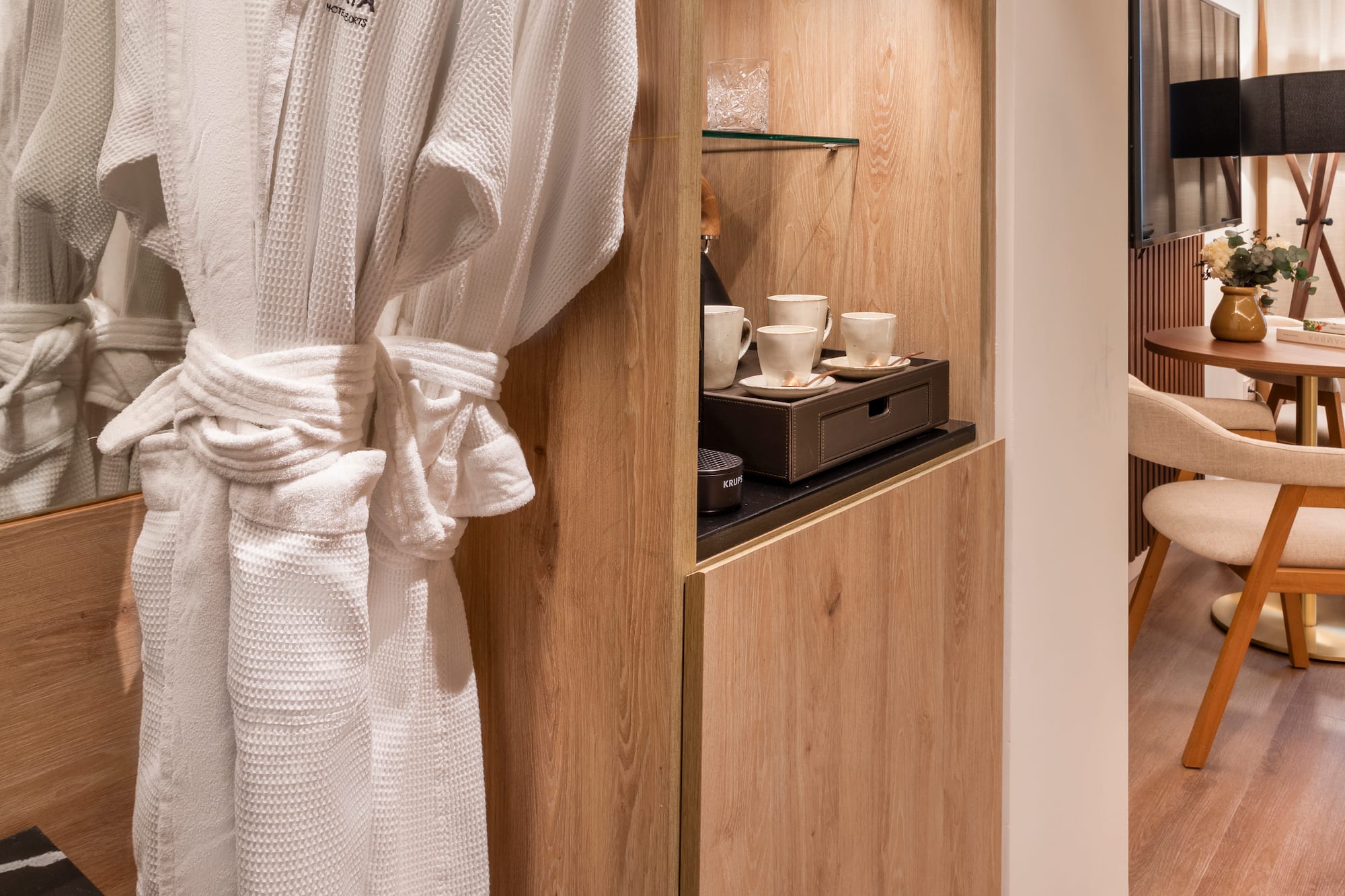 a white robe on a rack in a room
