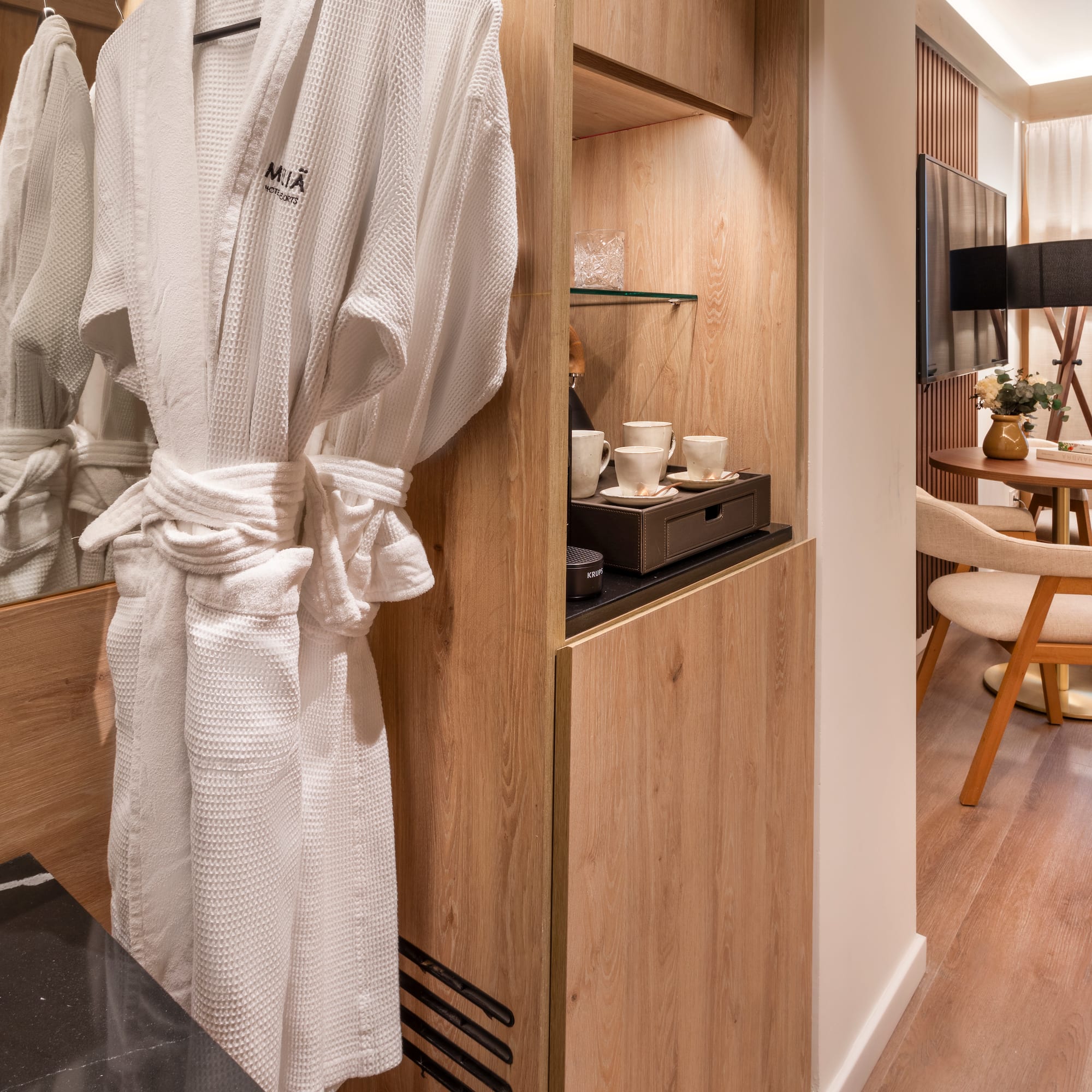 a white robe on a rack in a room